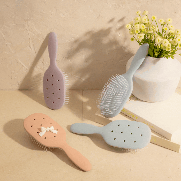 Hairbrushes with decorative elements on a beige background
