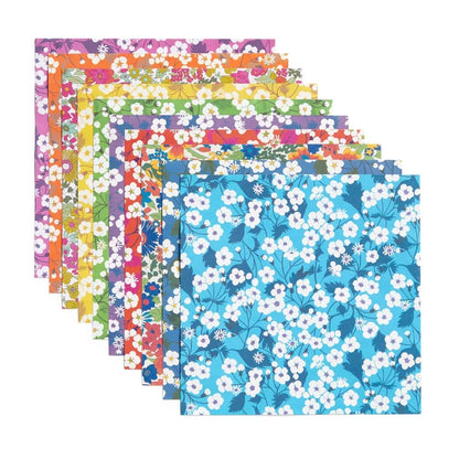 Set of colorful floral-patterned paper sheets on a white background