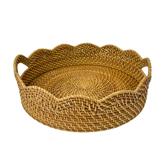 Woven rattan tray with scalloped edge and handles on a white background
