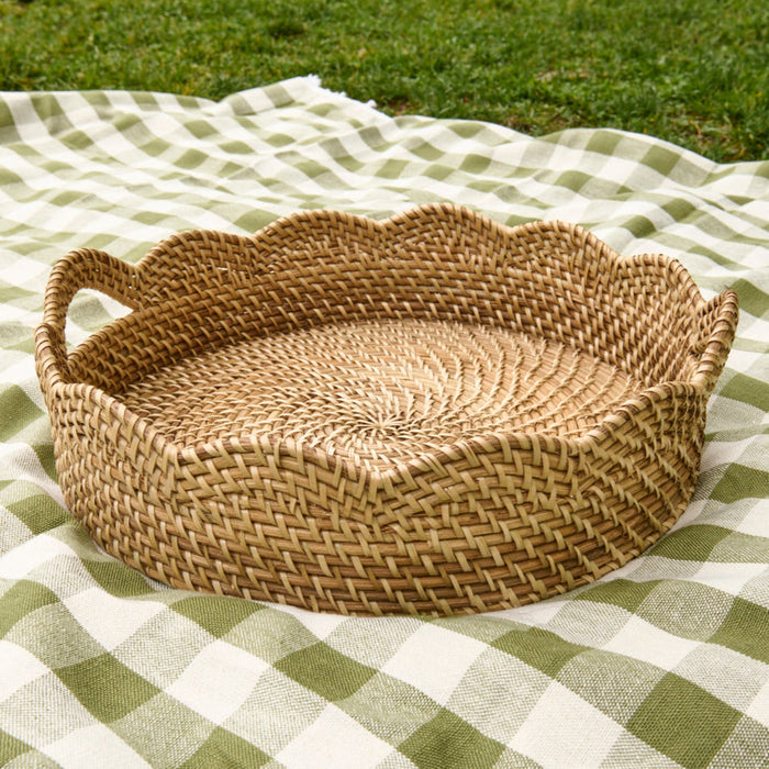 Woven basket on a green and white checkered blanket outdoors