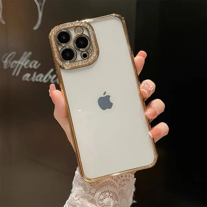 someone holding a white iphone with a gold case on it