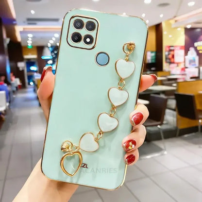 a woman holding a phone case with a heart charm
