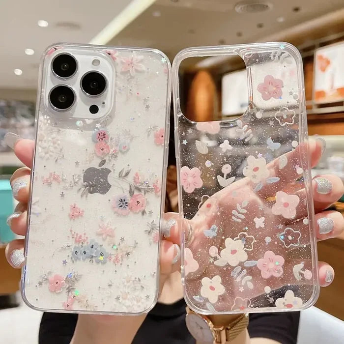 A woman holding up a phone case with a pink and silver glitter
