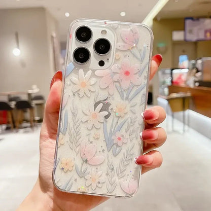 A woman holding a phone case with flowers on it