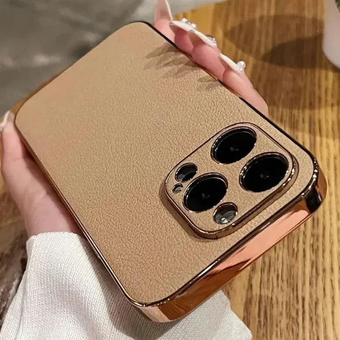 someone holding a gold case with three black buttons on it