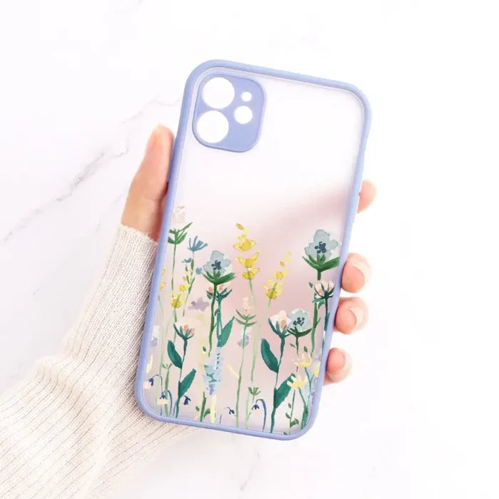 A woman holding a phone case with flowers on it