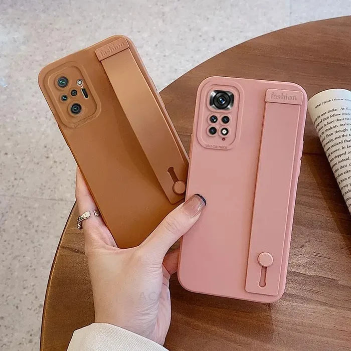 a woman holding a pink iphone case