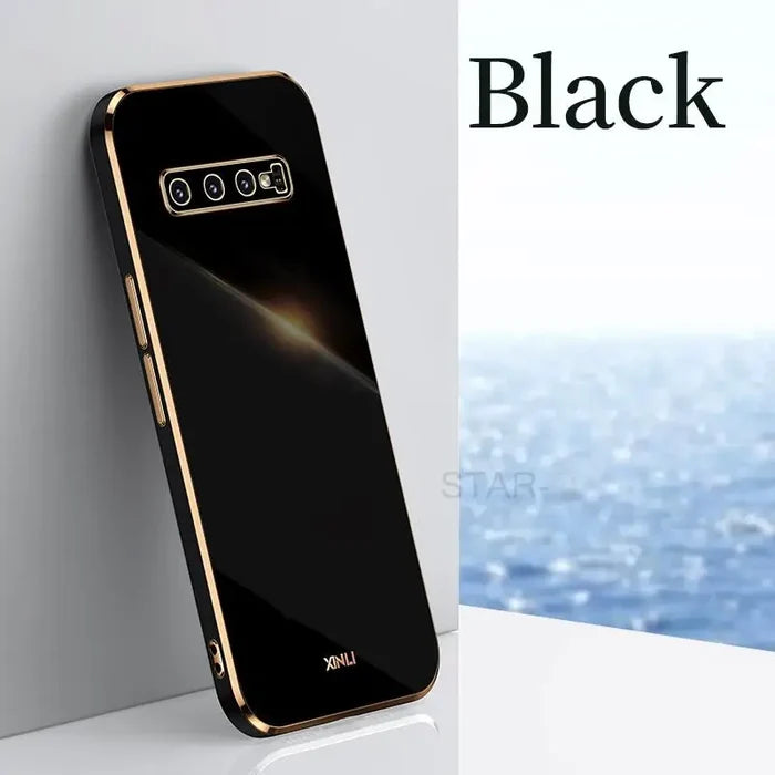 the back of a black phone with a gold frame