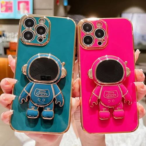 a person holding up two cell cases