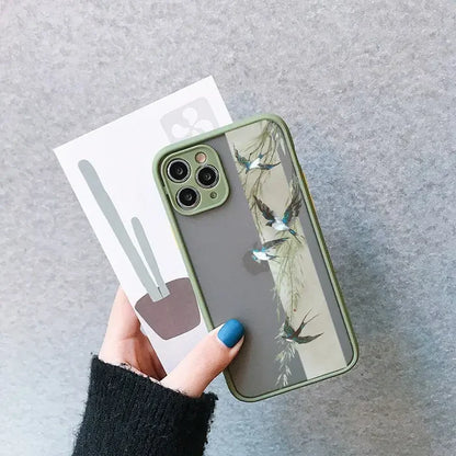 a woman holding a phone case with a bird print