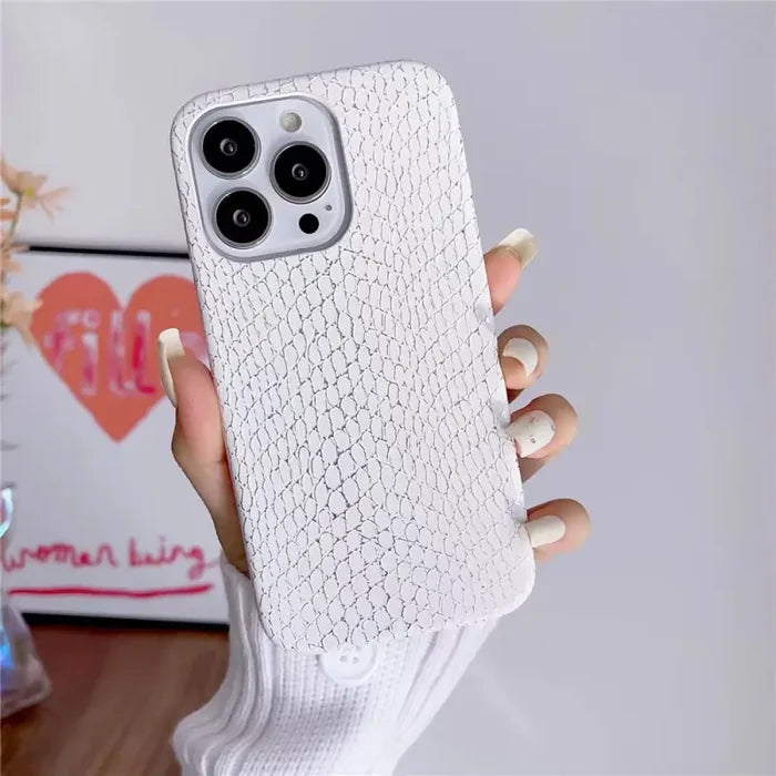 a woman holding a white iphone case