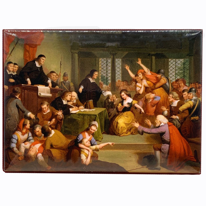 A magnet depicting a historical scene of the trial of George Jacobs, with various figures seated and speaking in a courtroom setting.