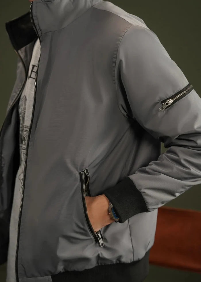 Grey winter jacket sleeve detail with zipper pocket and elastic cuff