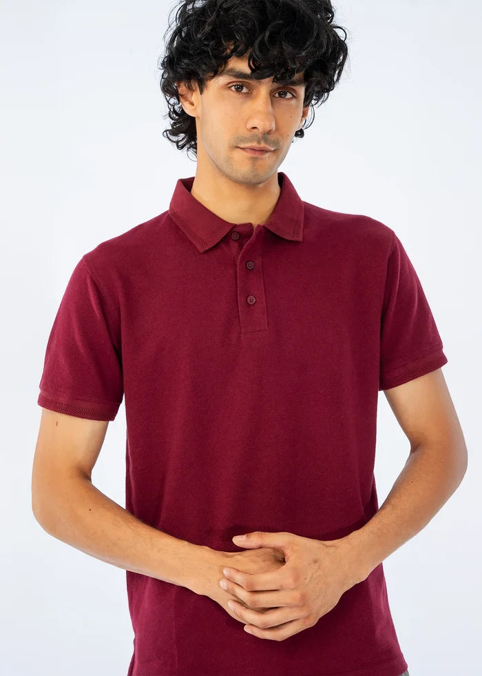 Maroon men's polo shirt close-up with buttoned placket and ribbed collar