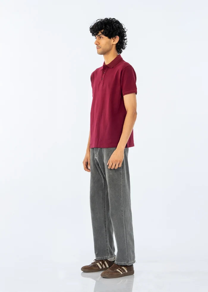Maroon men's polo shirt, short sleeves and button placket, side view