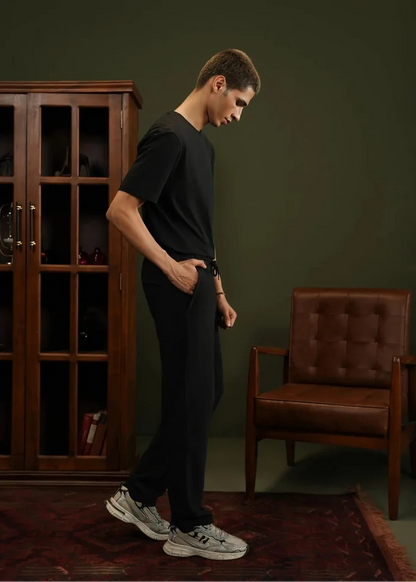 Men's black pull-on winter trousers, side view with drawstring waist and cuffed hem