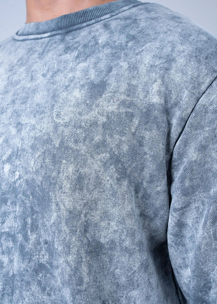 Grey terry sweatshirt fabric close-up, crew neck seam detail at shoulder.