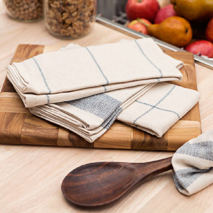 A set of four folded striped kitchen towels in natural and blue denim colors.