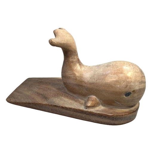 Carved wooden doorstop in the shape of a whale, with a platform under it.