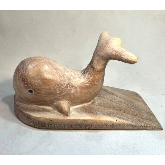 Carved wooden doorstop in the shape of a whale, with a platform under it.