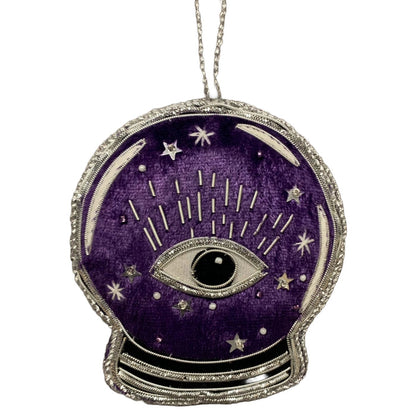A purple velvet crystal ball ornament with silver metallic applique, featuring an eye and stars design, and the word 'Salem' on the reverse.