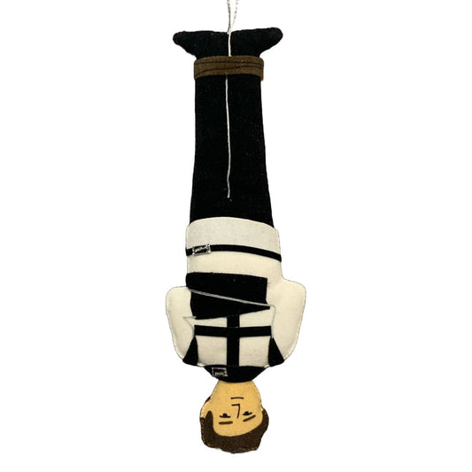A handmade ornament of Harry Houdini wearing a straightjacket while hanging from his feet.