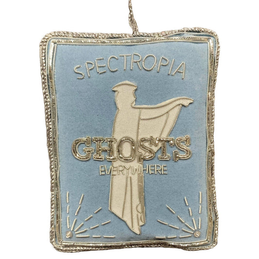 A handmade Spectropia Book Ornament featuring silver metallic applique on pale blue, with the text 'Spectropia' and 'Ghosts Everywhere'.
