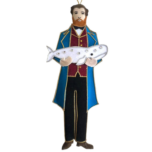 Decorative ornament of a man in a blue coat holding a whale on a white background