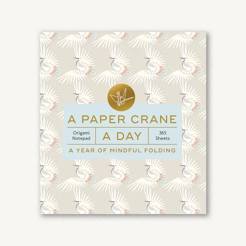 Notebook with paper crane design and text on a white background