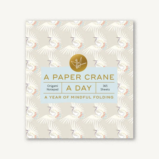 Notebook with paper crane design and text on a white background