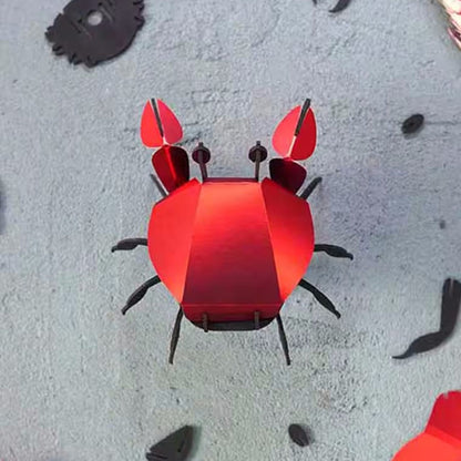 Red paper crab craft on a textured surface
