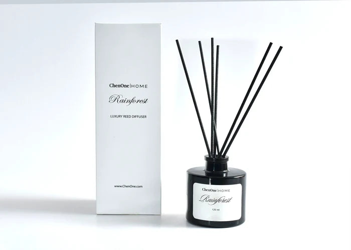 Luxury reed diffuser with black glass bottle, dark reed sticks, and white gift box
