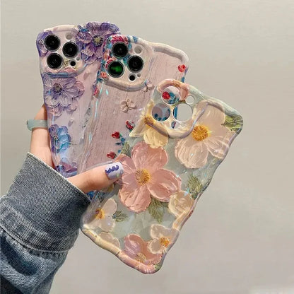 a woman holding a phone case with flowers on it