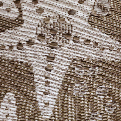 Close-up of a textured fabric with a pattern of shapes and lines.