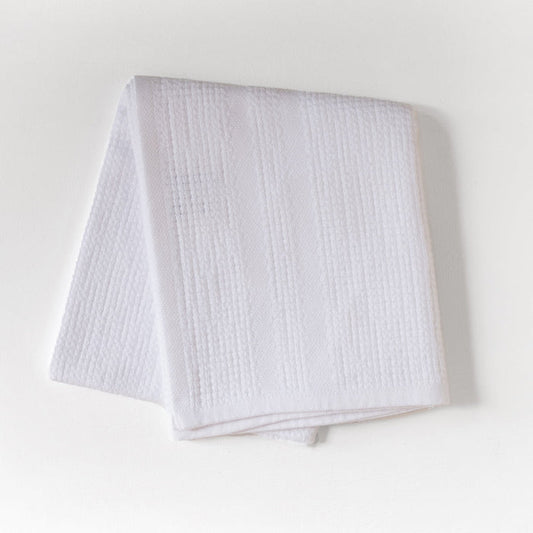 White textured fabric on a light gray background