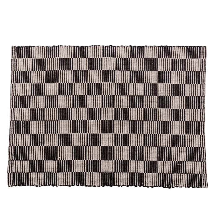 Checkerboard patterned placemat in black and cream on a white background.