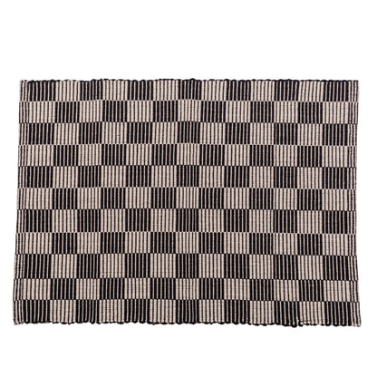 Checkerboard patterned placemat in black and cream on a white background.