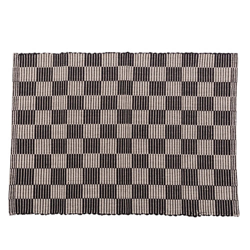 Checkerboard patterned placemat in black and cream on a white background.