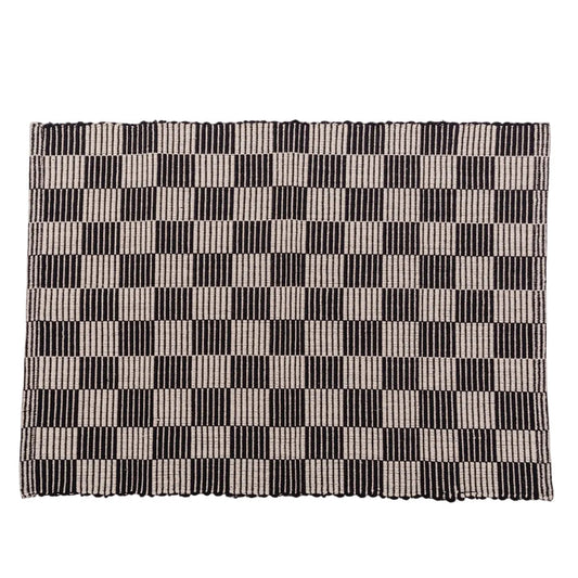 Checkerboard patterned placemat in black and cream on a white background.