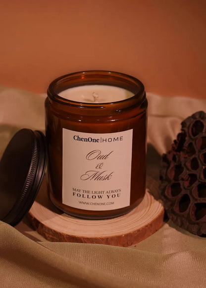 Amber glass jar scented candle with open top, white wax, Oud & Musk label