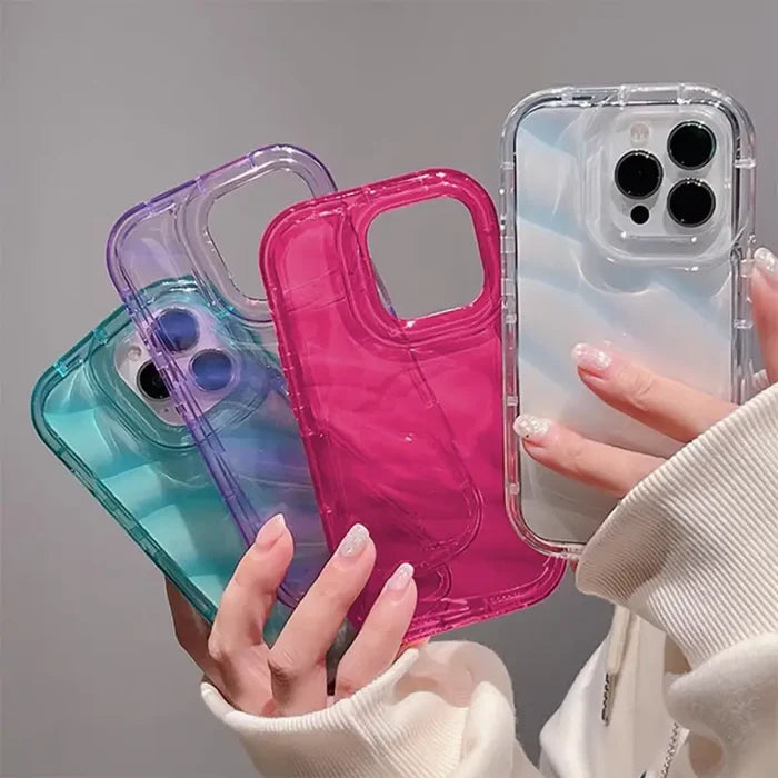 a woman holding a phone case with a pink and blue case