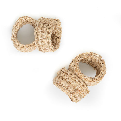 A set of four beige handwoven napkin rings on a white background.
