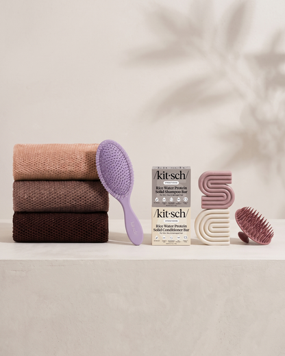 Kitsch Spring Welcome Kit Rice Water shown as a full bundle with the Strengthening Rice Water Shampoo and Conditioner Bars, Soft Violet Wet/Dry Brush, Terracotta Scalp Exfoliator and Rosewood African Net Sponge on a soft neutral background