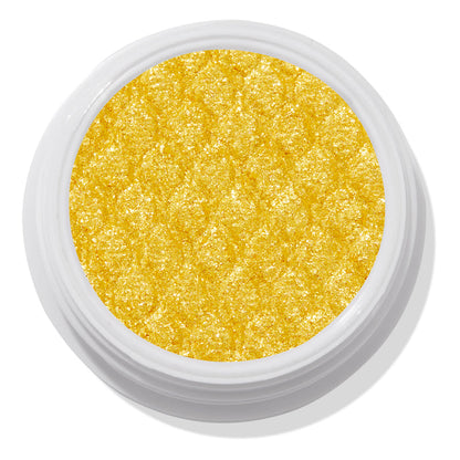 ColourPop Super Shock Shadow Tankini shows a vibrant metallic yellow‑gold pan sparkling with a quilted, bouncy texture, sitting open in a white jar against a clean white studio background.