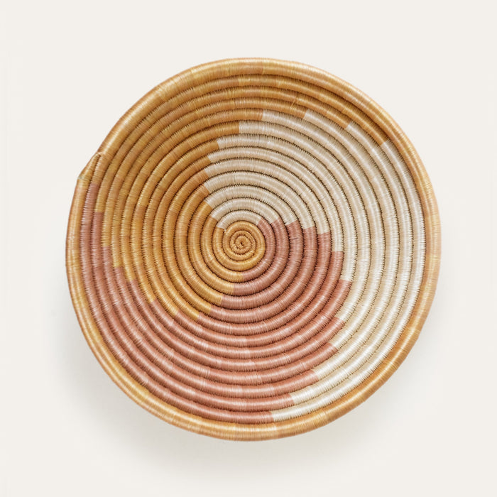 Woven basket with concentric circle pattern on a light background