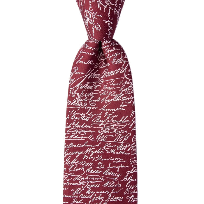 Red tie with black text pattern on a white background