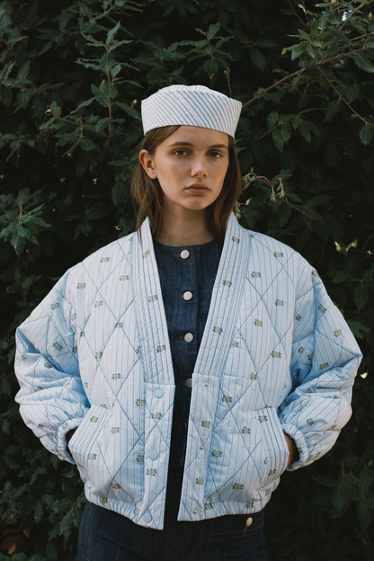 Tiny Big Sister striped jacket with delicate mini floral detail, softly padded and fully lined. A fresh, stylish layer for spring. Shop at Dotique.
