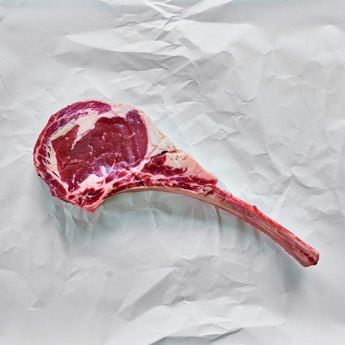 Tomahawk ribeye on parchment paper