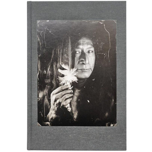 Book cover for 'Tomas van Houtryve: Lines and Lineage' with a black and white photograph of a Native American holding a feather