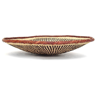 A round, beige-colored woven basket with a geometric pattern and a coiled rim.